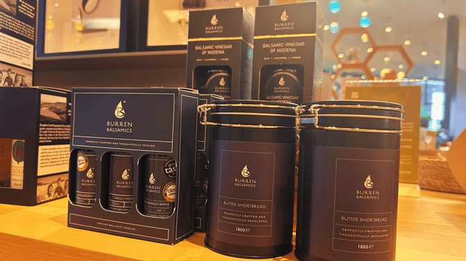 Display of Burren Balsamics products in the Giant's Causeway Visitor Centre Retail area, including a gift set of 3 small balsamic vinegar bottles and 2 tins of butter shortbread